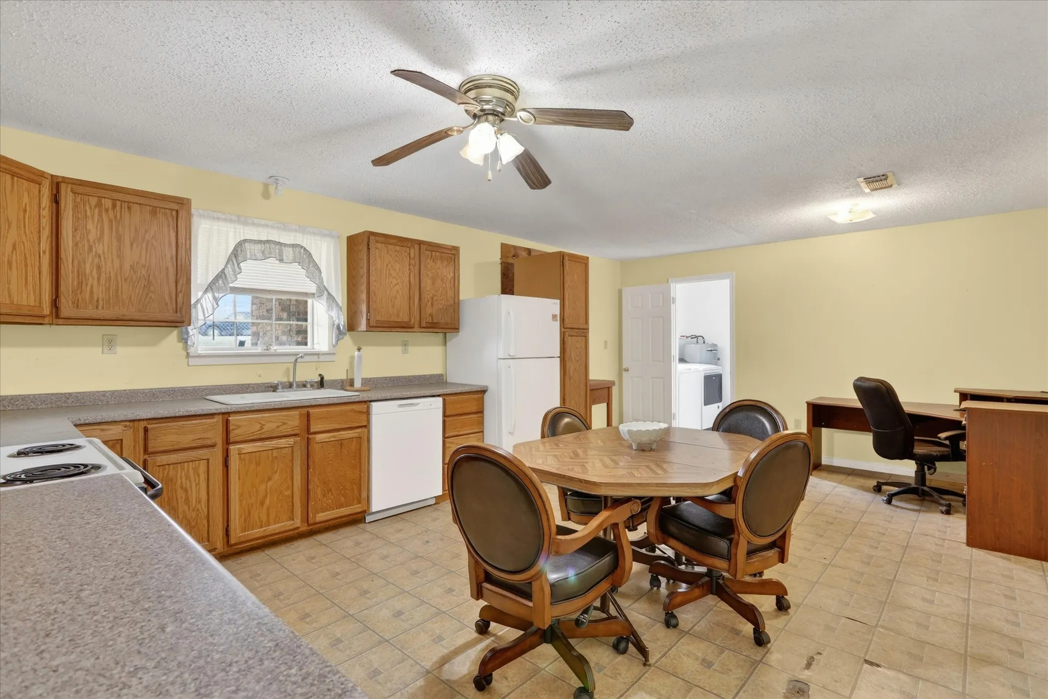 Spacious kitchen with door leading to laundry room and half bath.