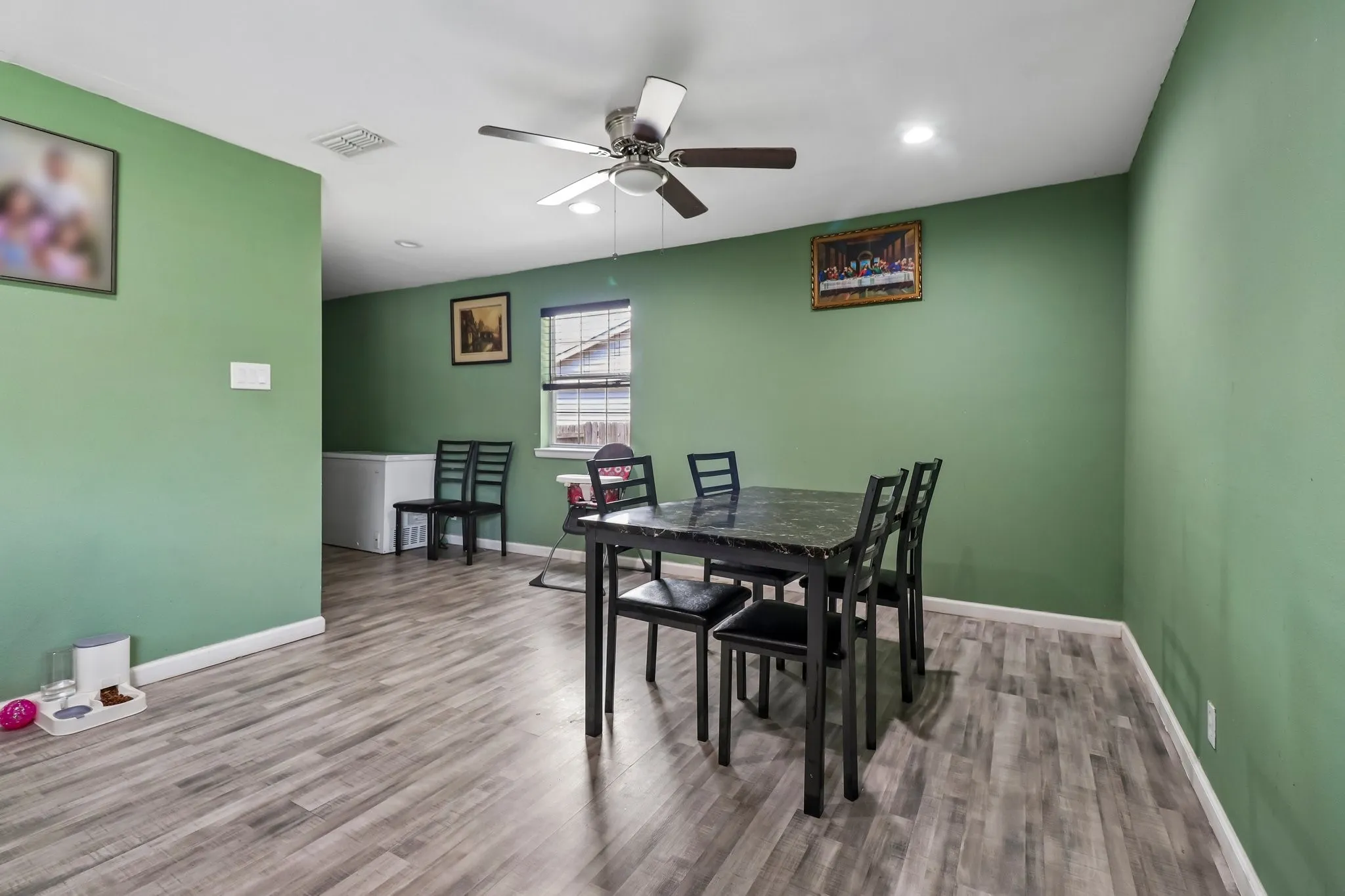 Wood-finish flooring, recessed lighting, ceiling fan, and window with blinds