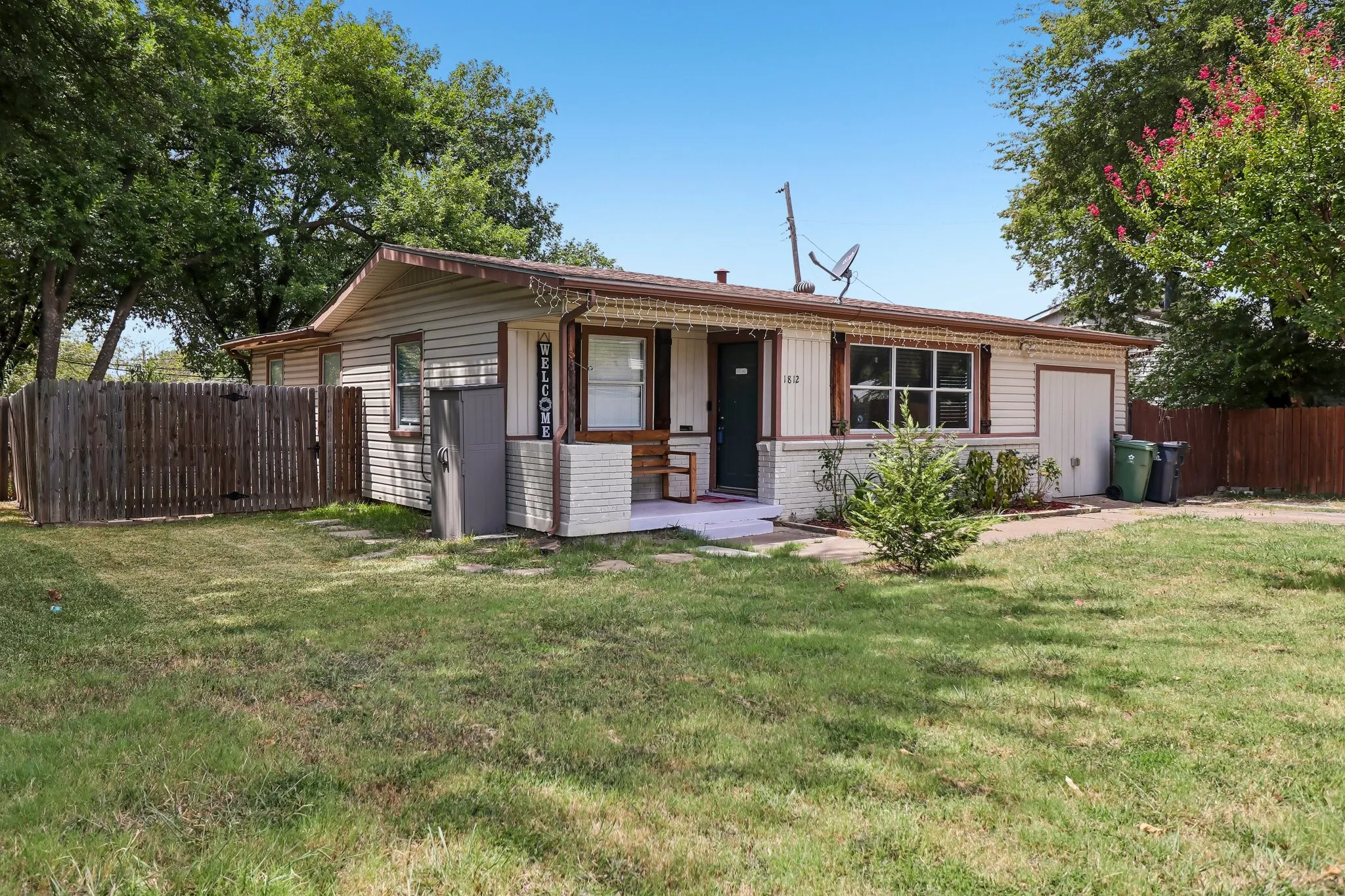 Single-story residence featuring horizontal siding and a fenced side yard