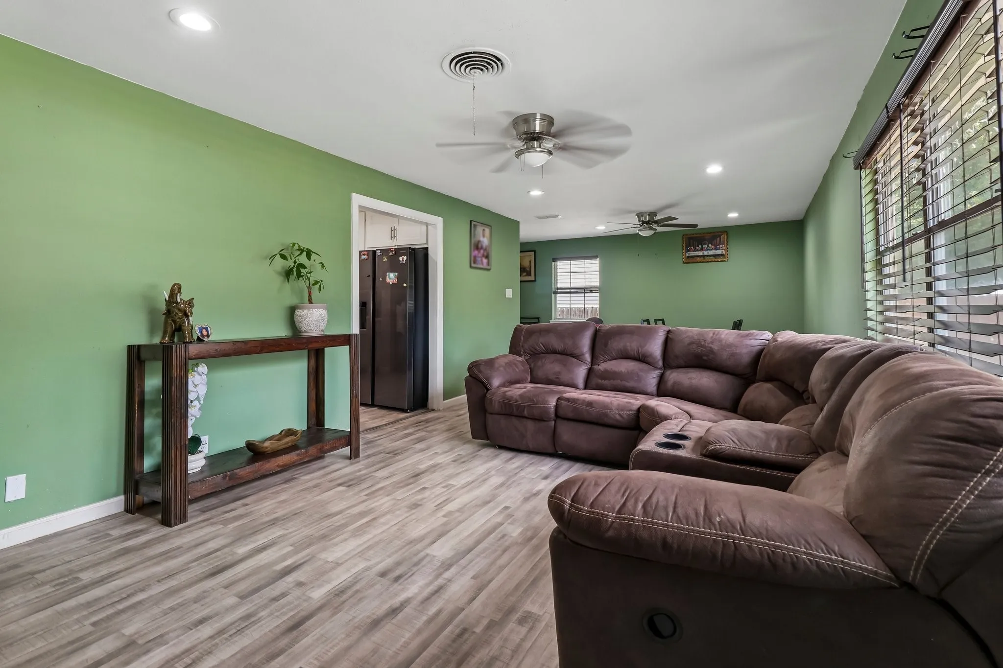 Wood-finish flooring throughout, recessed lighting, and ceiling fans