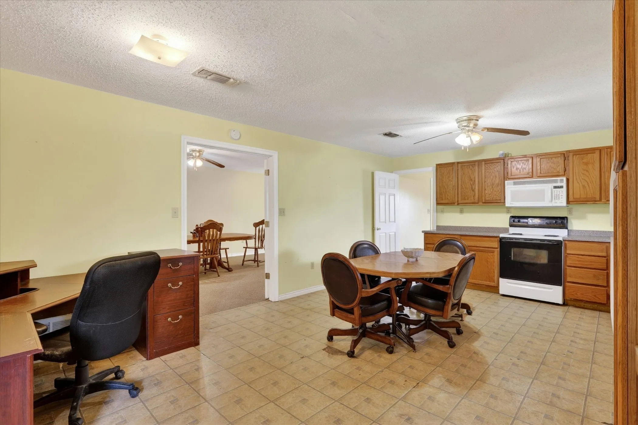 Kitchen with range, microwave and ceiling fan