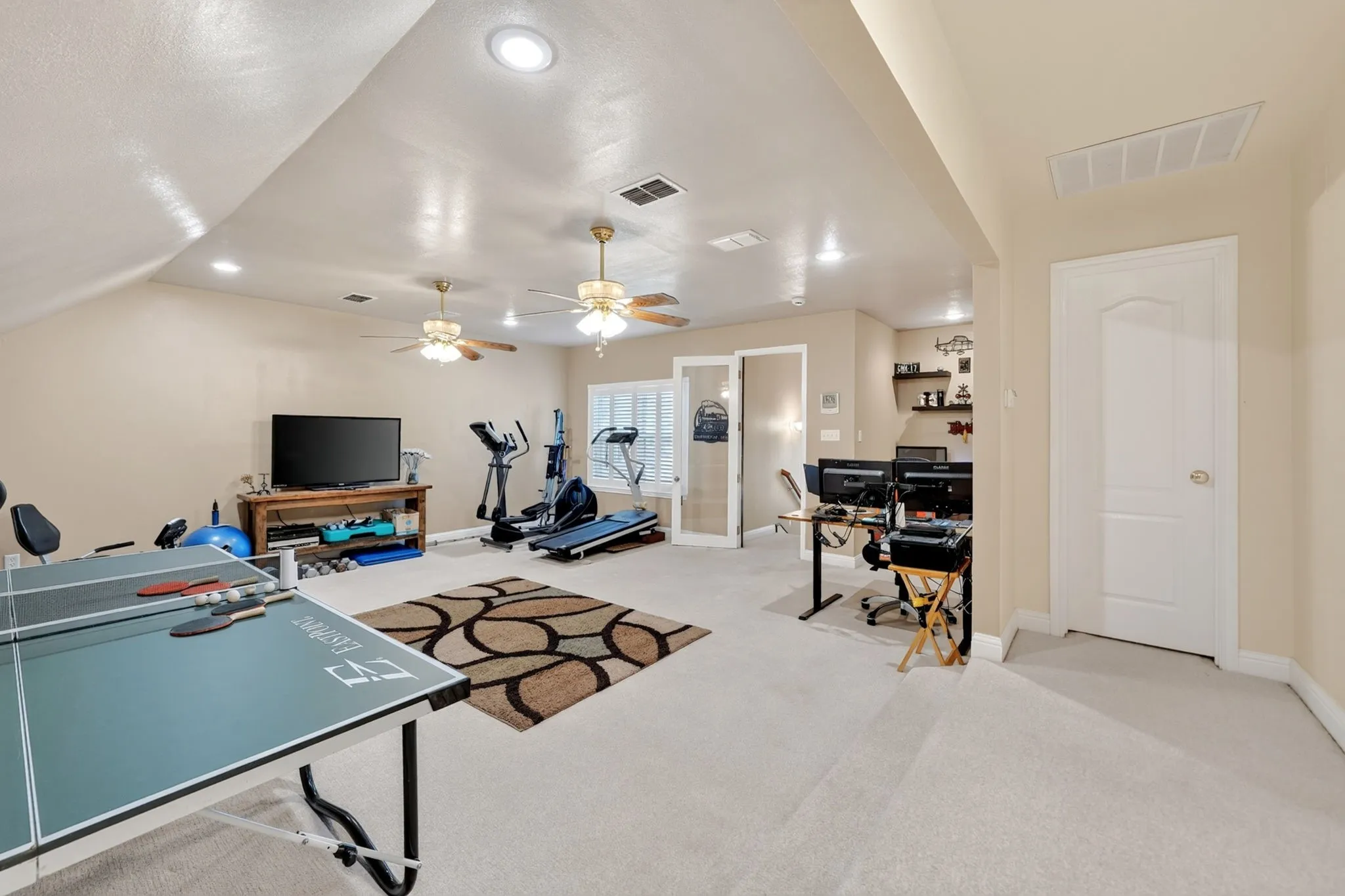 Spacious bonus room featuring neutral carpeting, recessed lighting, and multiple ceiling fans