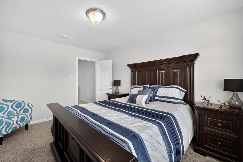 Neutral wall paint with carpet flooring, a flush-mount ceiling light fixture, and a white interior door