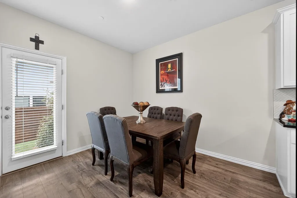 Dining area featuring wood-finish flooring, white baseboards, and neutral wall paint