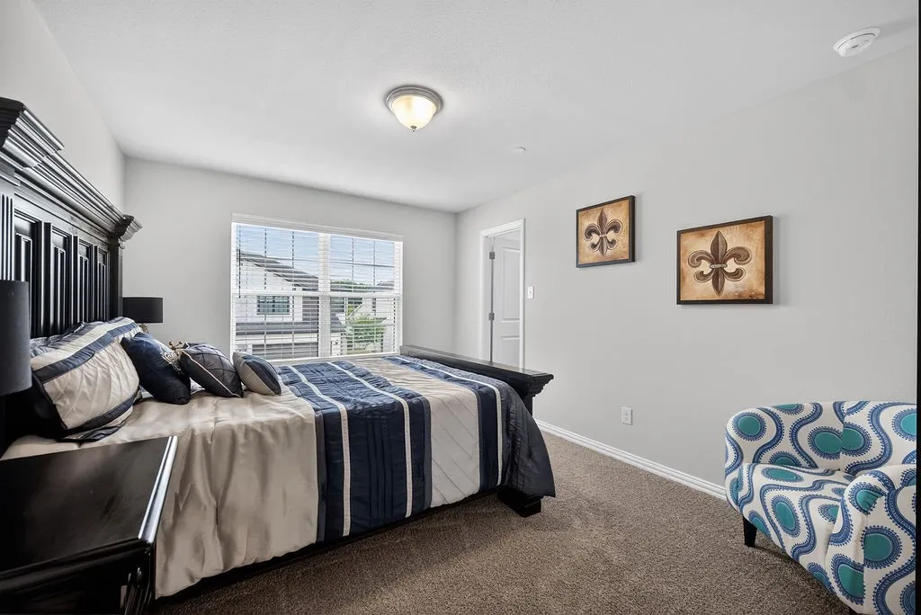 Carpeted room featuring light gray walls, a window with horizontal blinds, a white ceiling, a flush mount light fixture, and a white interior door frame