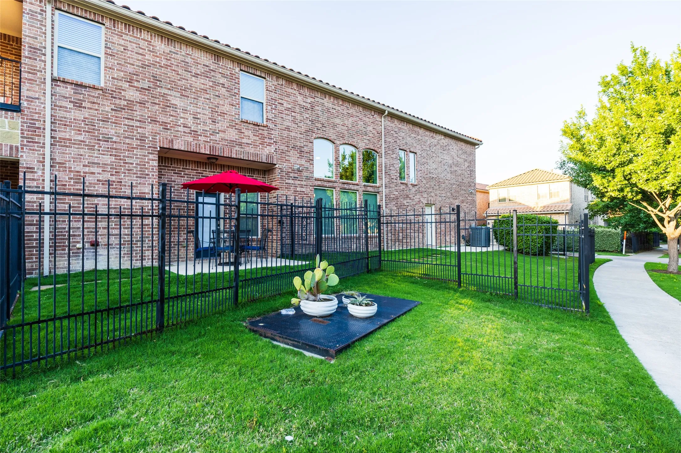 Concrete patio enclosed by wrought iron fencing. Rear yard has "dig guard" to keep your bets from digging out or nature from getting in.