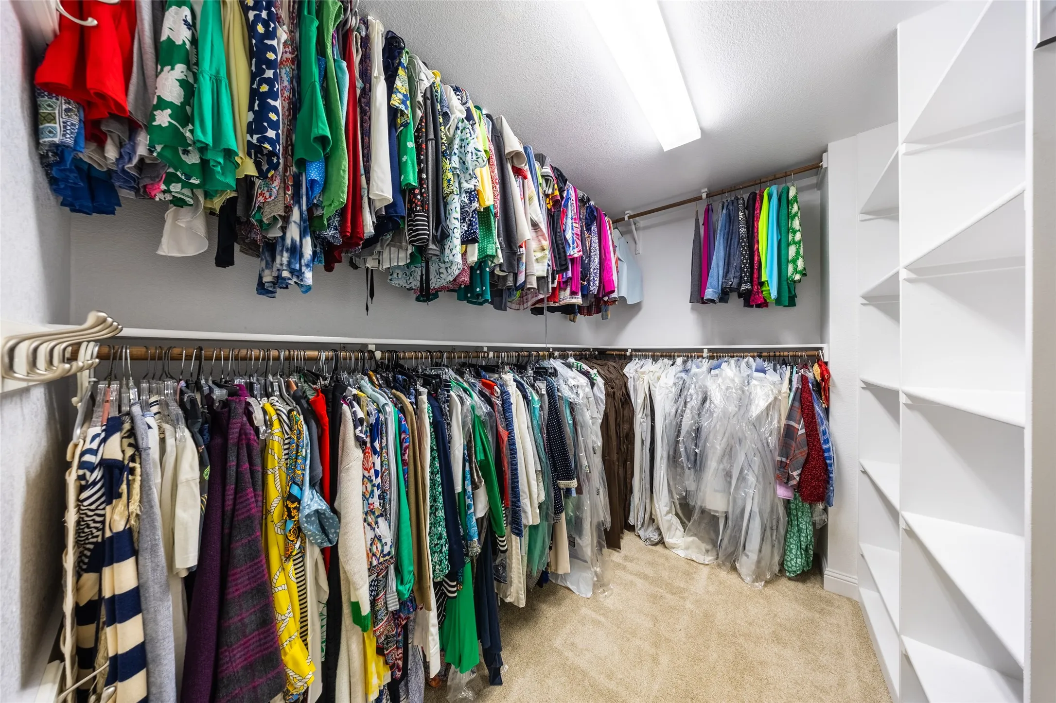 Walk-in closet In Primary Bedroom, featuring built-in shelving, multiple system, and recessed overhead lighting
