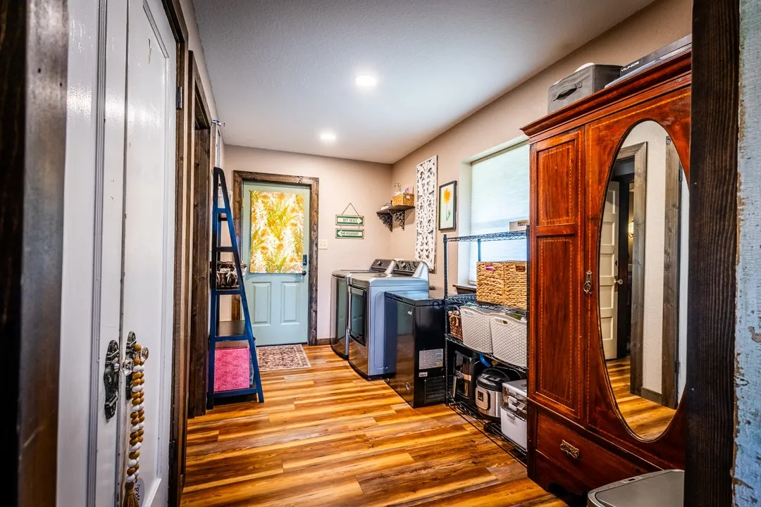 Entry from the back of the house leads into the laundry room which opens into the kitchen area.