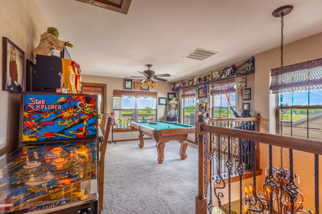 This spacious room at the top of the stairs could easily be a second living area, family room, or the current game room setting. Note the many windows for the BIG VIEWS from up here.