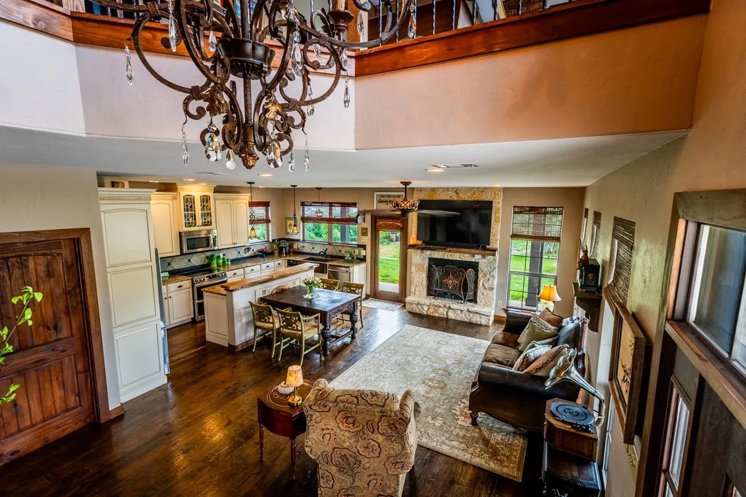 Living room, dining area and kitchen viewed from stairway; closet door leads to the laundry room.