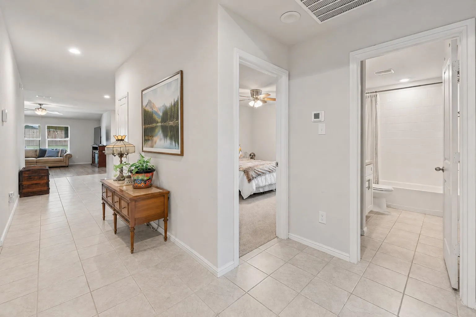 Front entry hall with guest bathroom and another one of the four bedrooms.