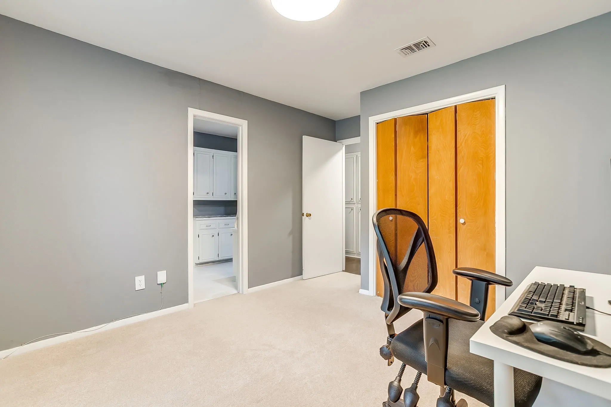 Room featuring neutral gray walls and light-colored carpet flooring