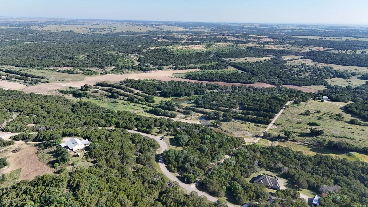 Expansive rural landscape featuring a mix of dense tree cover and open fields