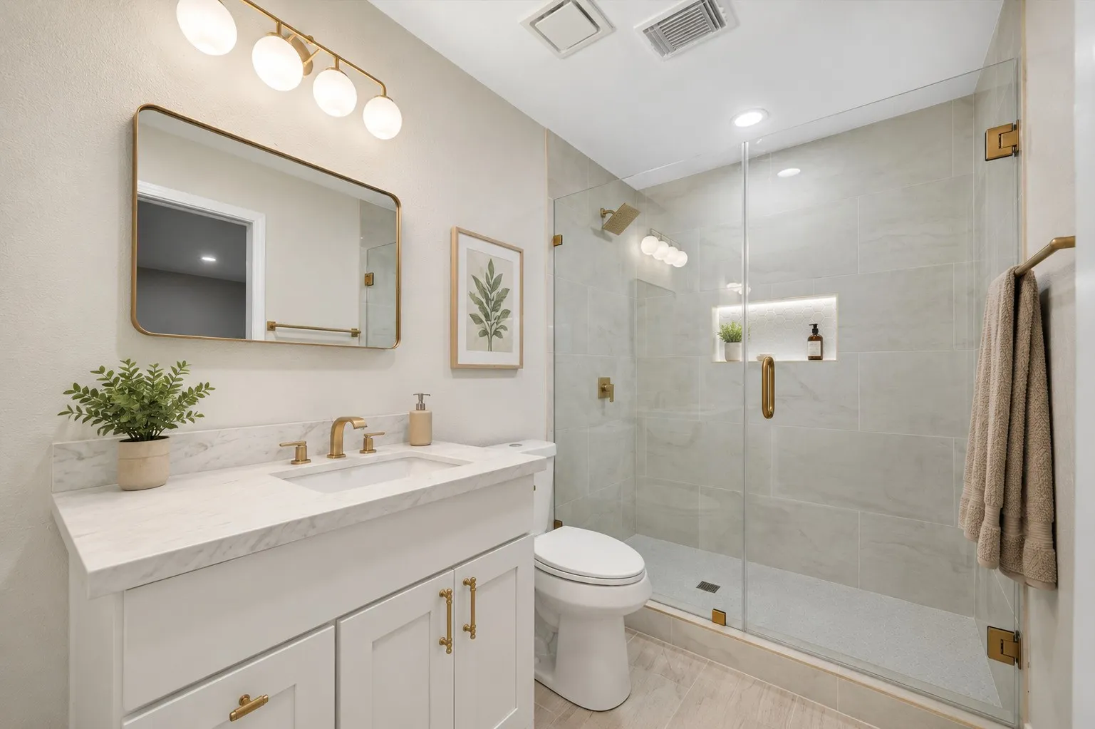 Bathroom featuring a frameless glass shower enclosure with a built-in niche, a white vanity with gold-finish hardware, a rectangular undermount sink, a stone-finish countertop, and wood-finish flooring