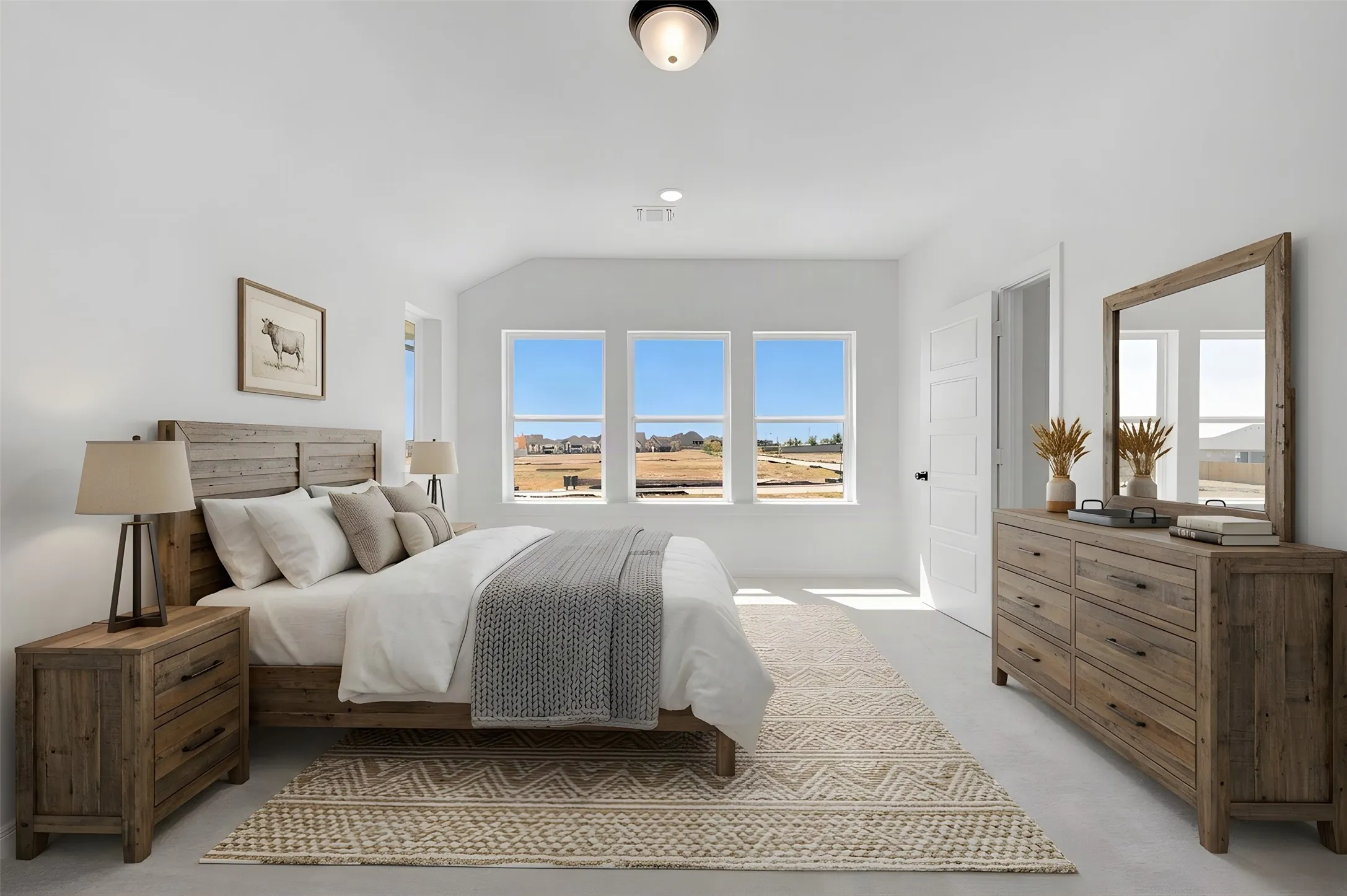 Recessed ceiling light fixture, three large windows with white trim, white paneled interior door, and light-colored flooring