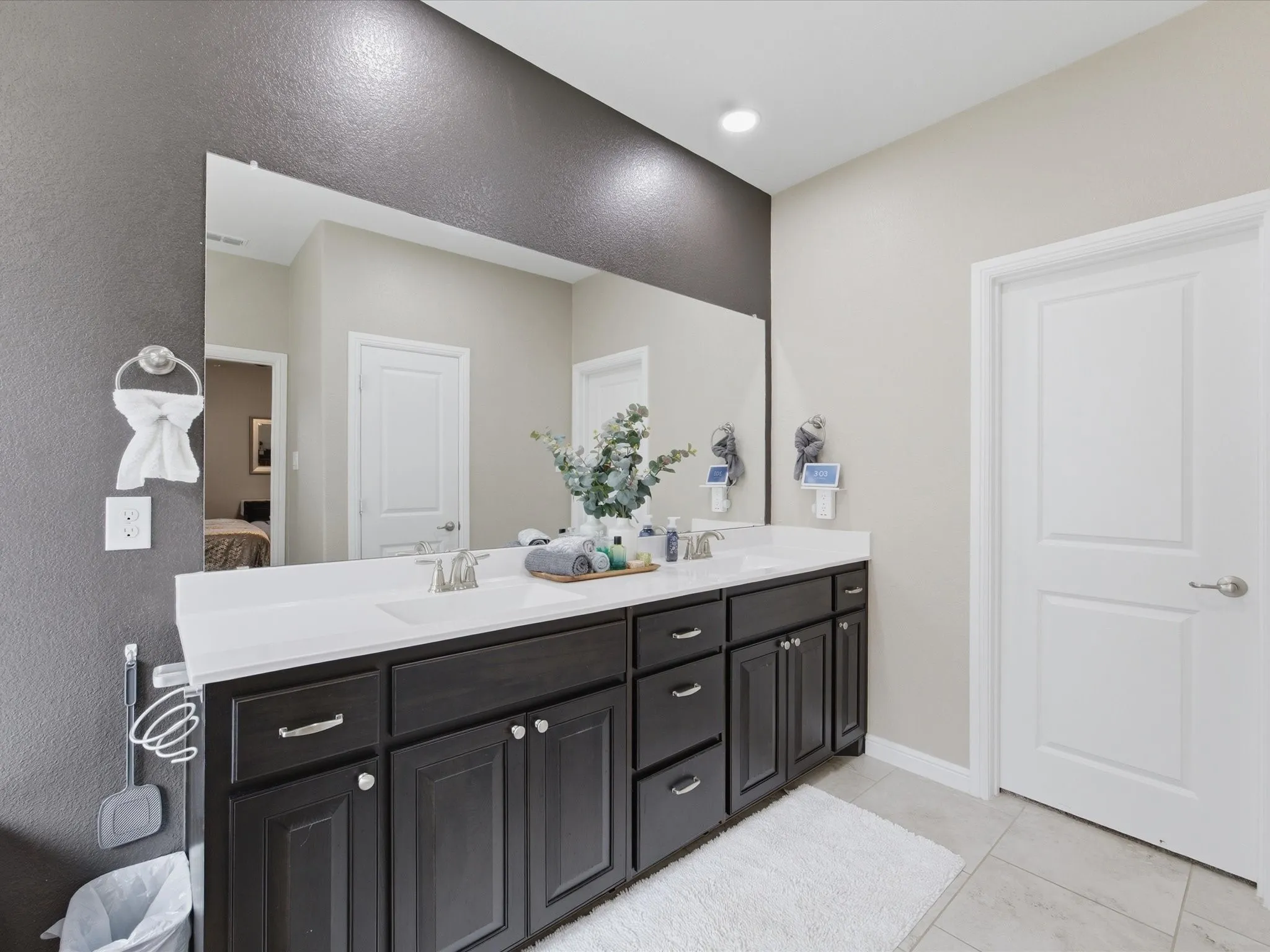 Dual vanity with dark wood-finish cabinetry and white countertops