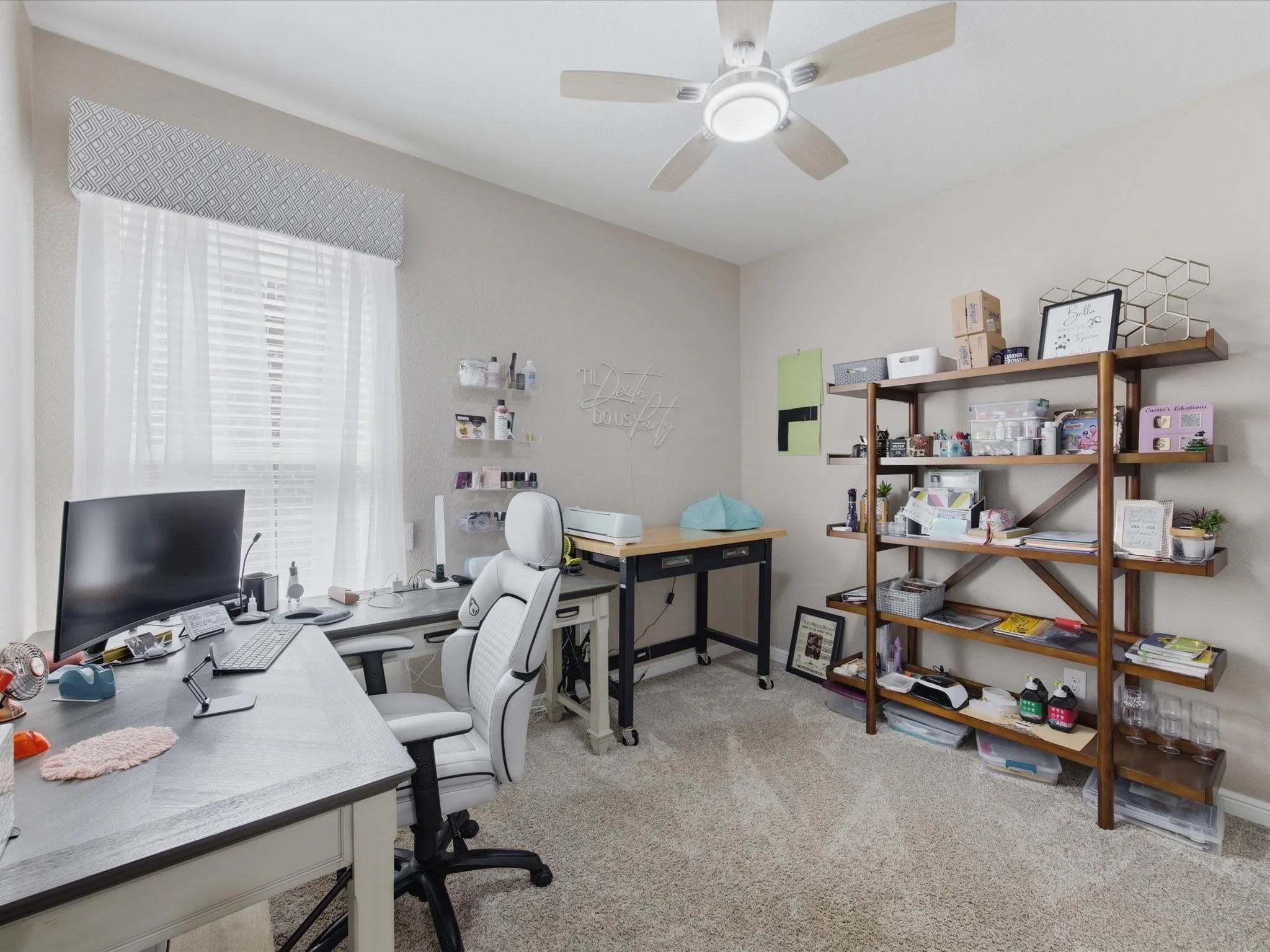 Versatile room featuring light-toned carpeting and a window with blinds and sheer curtains