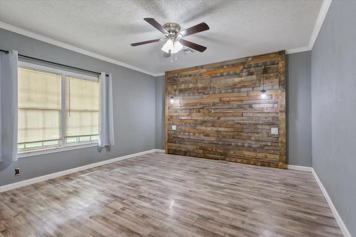 Accent wall featuring horizontal wood planks and pendant lighting