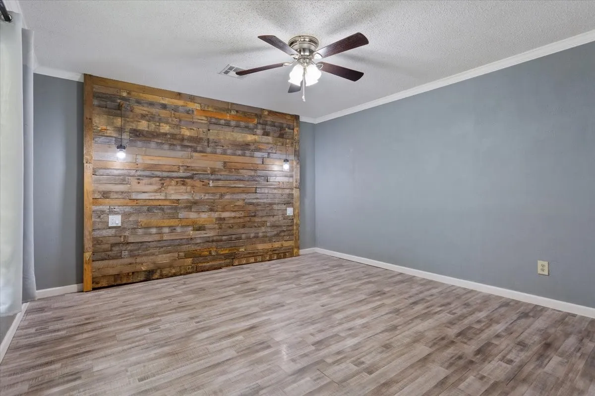 Accent wall featuring horizontally laid wood planks and two pendant lights