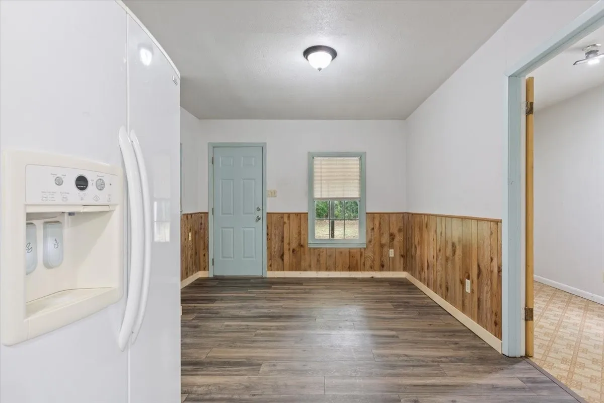 Wood-finish flooring throughout, complemented by natural wood paneling