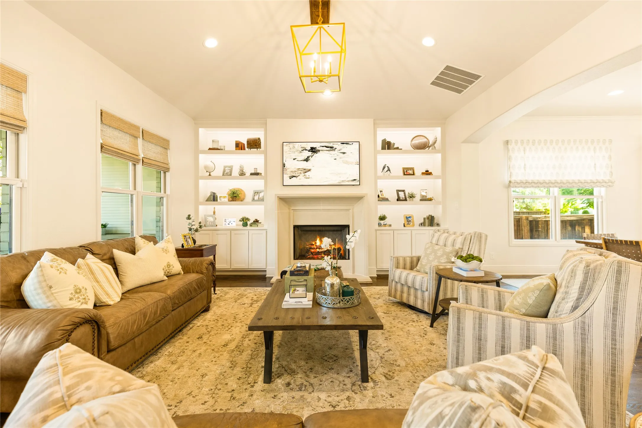 Light filled living spaces feature warm wood accents, custom built ins, and an open concept design that blends comfort and elegance throughout the home.