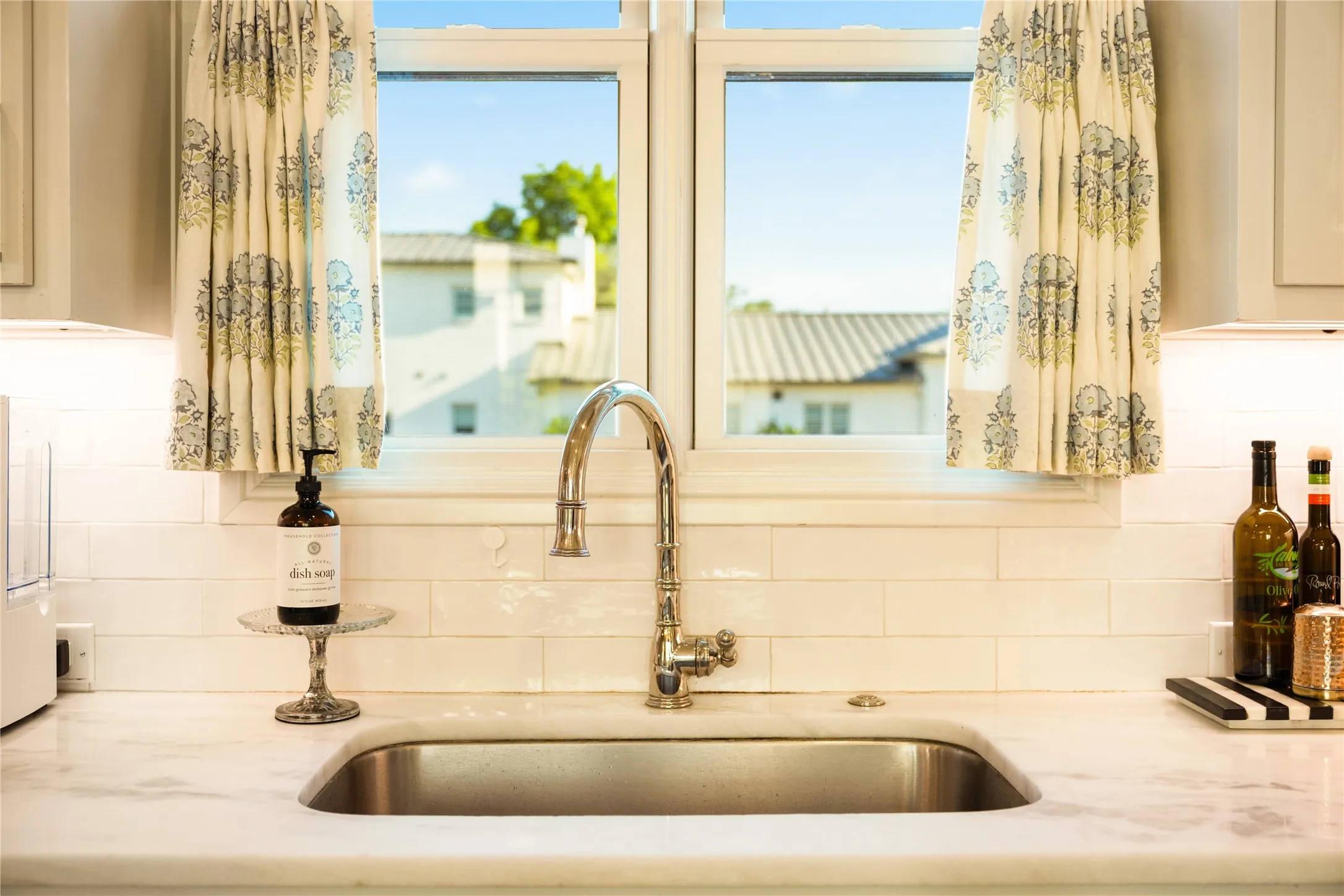 Large kitchen window fills the space with natural light while offering peaceful views and a bright, airy feel at the sink.