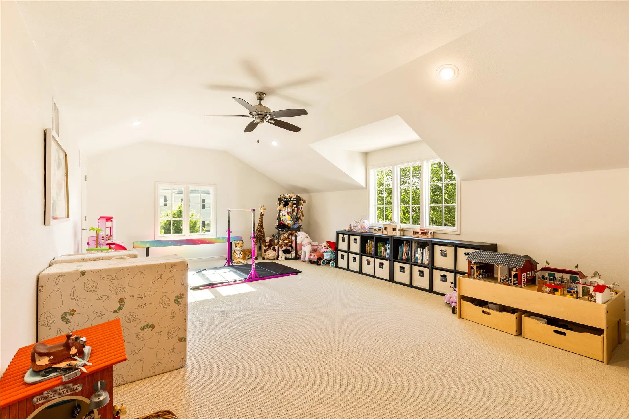 Comfortable secondary bedroom offers a bright and airy layout with soft carpet flooring, abundant natural light, and flexible space for family or guests.