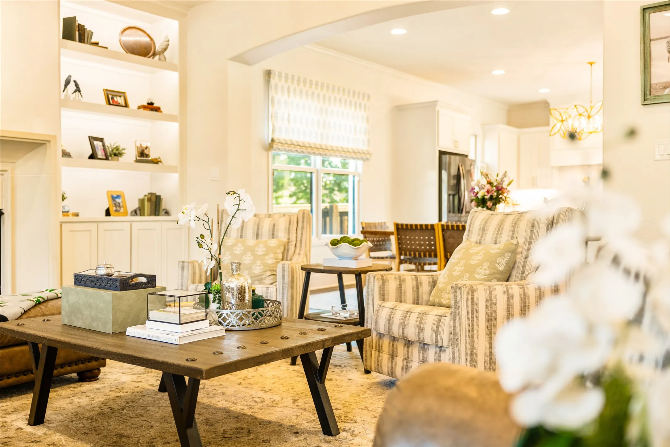 Light filled living spaces feature warm wood accents, custom built ins, and an open concept design that blends comfort and elegance throughout the home.