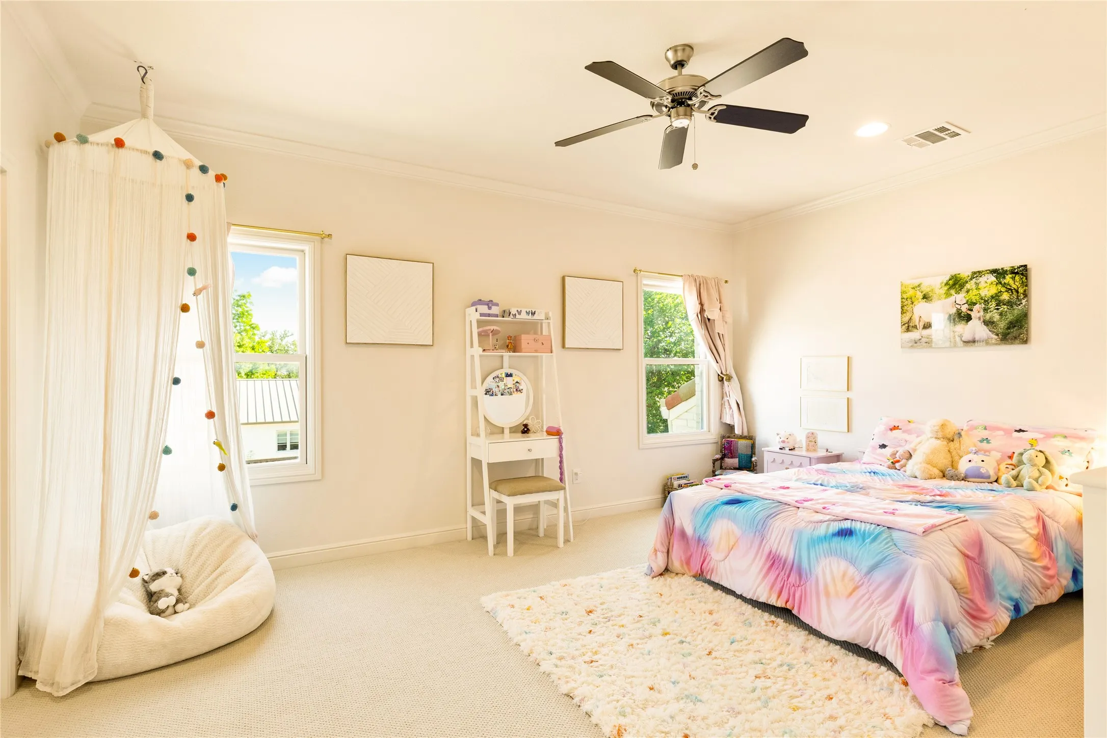Spacious secondary bedroom features soft carpet flooring, abundant natural light, and a bright, comfortable layout perfect for family or guests.