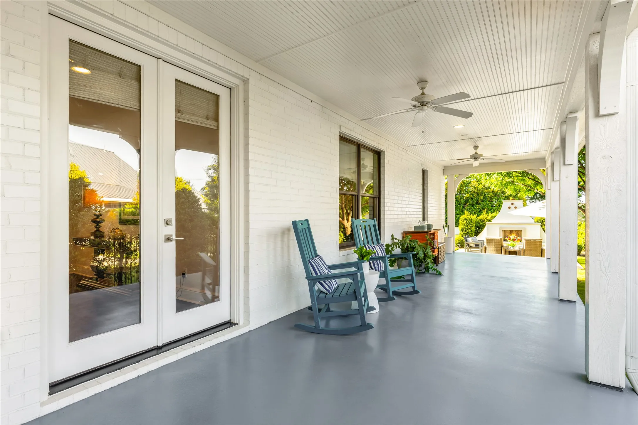 Covered outdoor patio offers the perfect setting for relaxing or entertaining with ample seating space, ceiling fans, and seamless indoor outdoor flow.