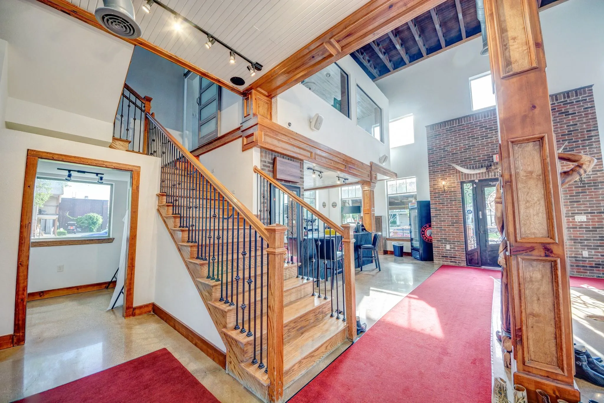Grand staircase with wood treads and wrought iron balusters