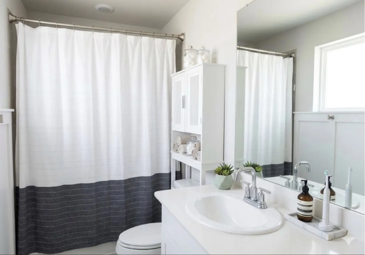 Bathroom featuring a white vanity with an undermount sink and chrome faucet