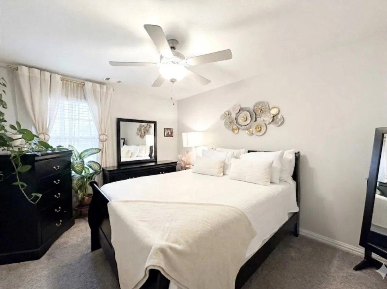 Light-filled interior featuring neutral wall tones and textured carpet flooring