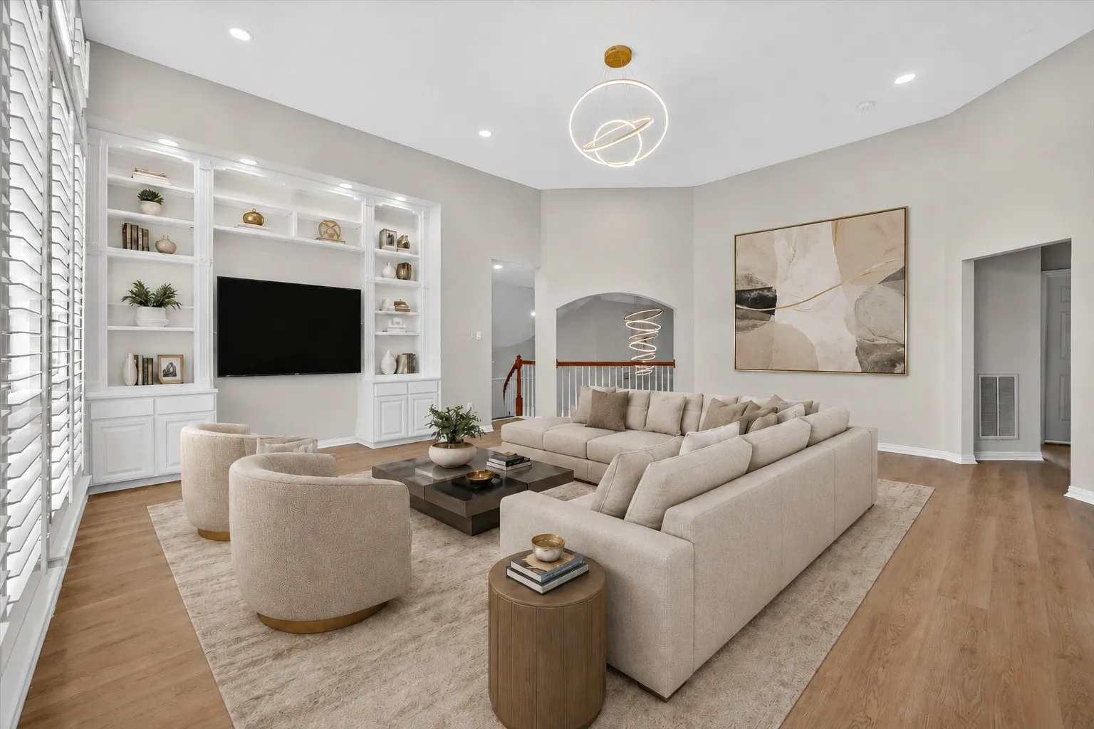 Spacious living area featuring high vaulted ceilings, recessed lighting, and wood-finish flooring