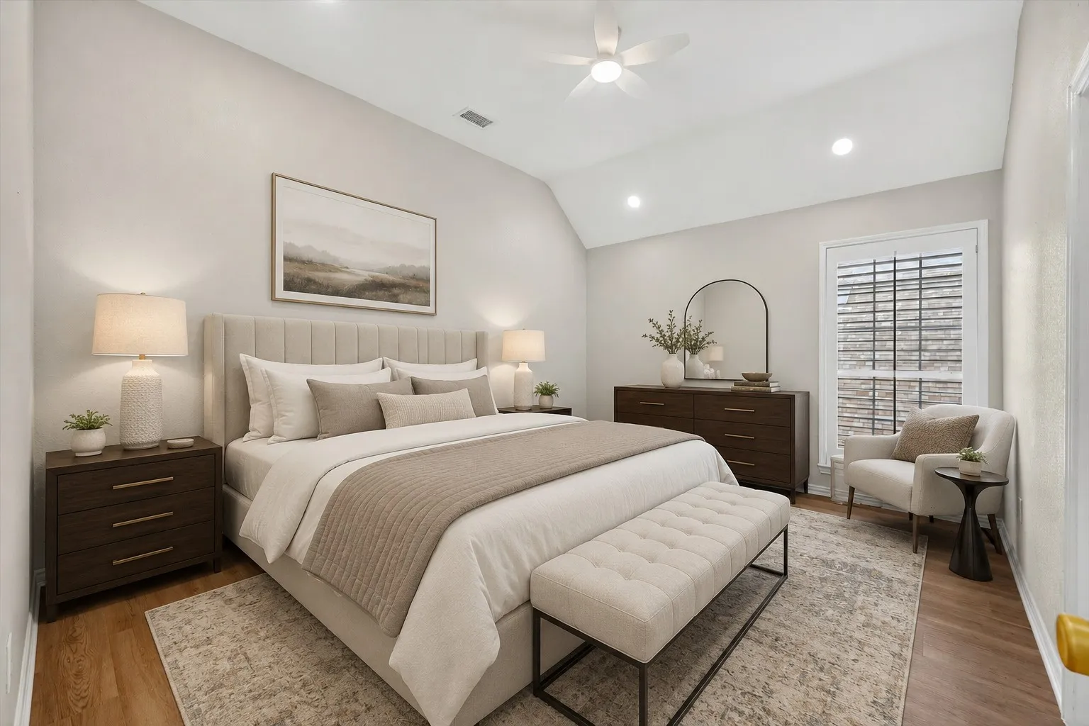 Spacious room featuring vaulted ceilings, recessed lighting, and wood-finish flooring