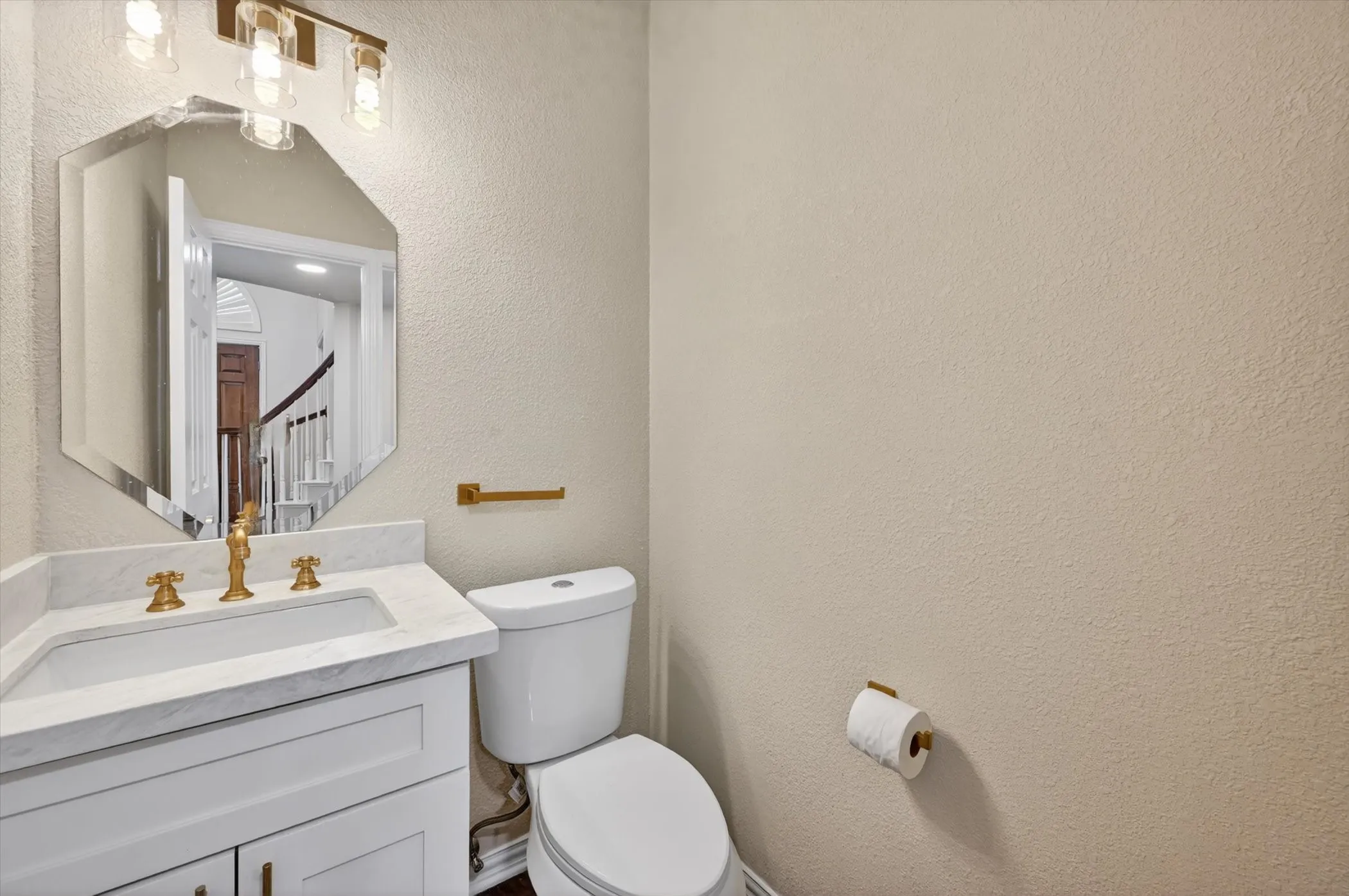 Vanity featuring white cabinetry, a rectangular undermount sink, and a light-toned countertop