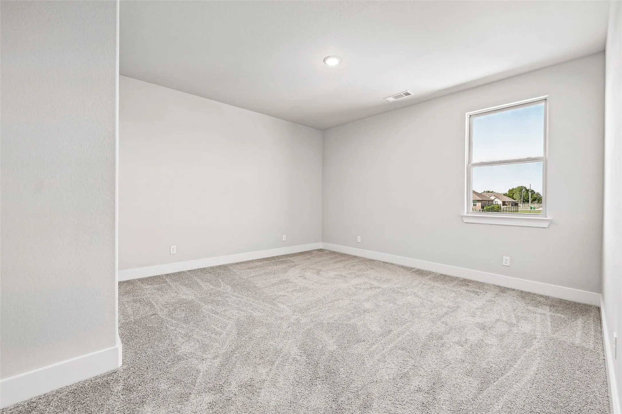 Light gray wall finishes, gray carpet flooring, recessed ceiling lighting, single window, and white trim