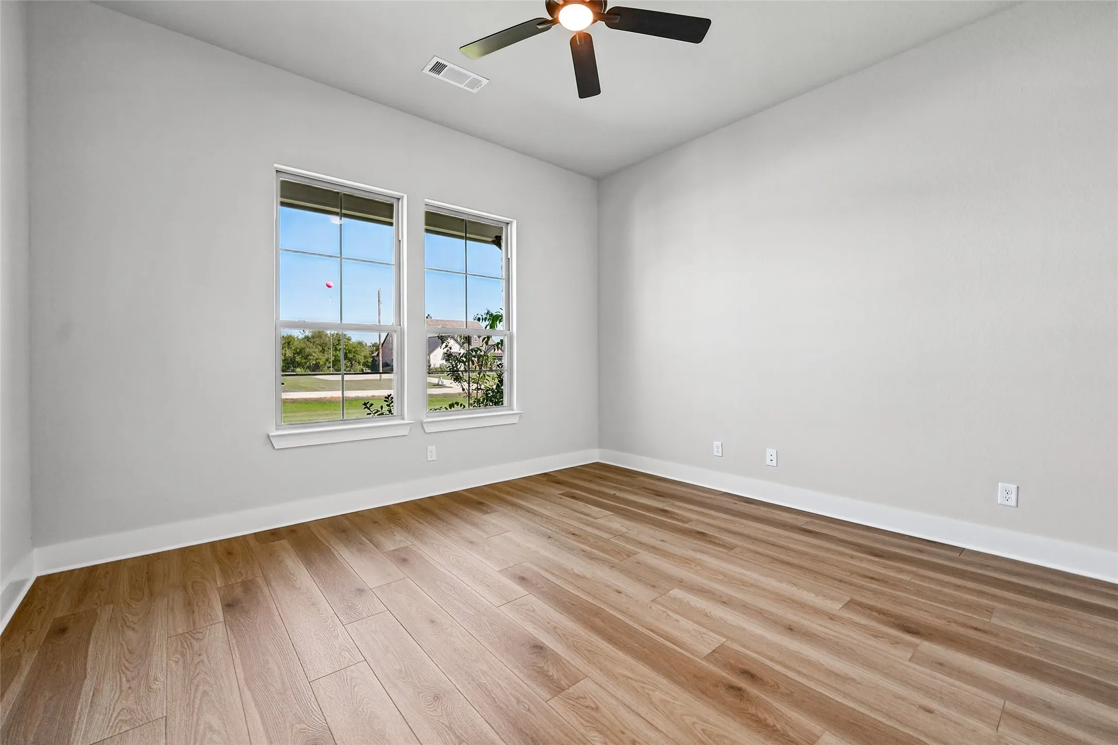 Recessed lighting, wood-finish flooring, and a ceiling fan
