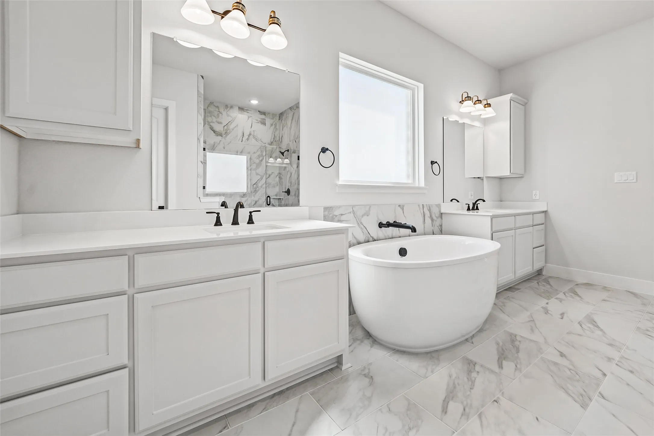 Dual vanity with white cabinetry and countertops