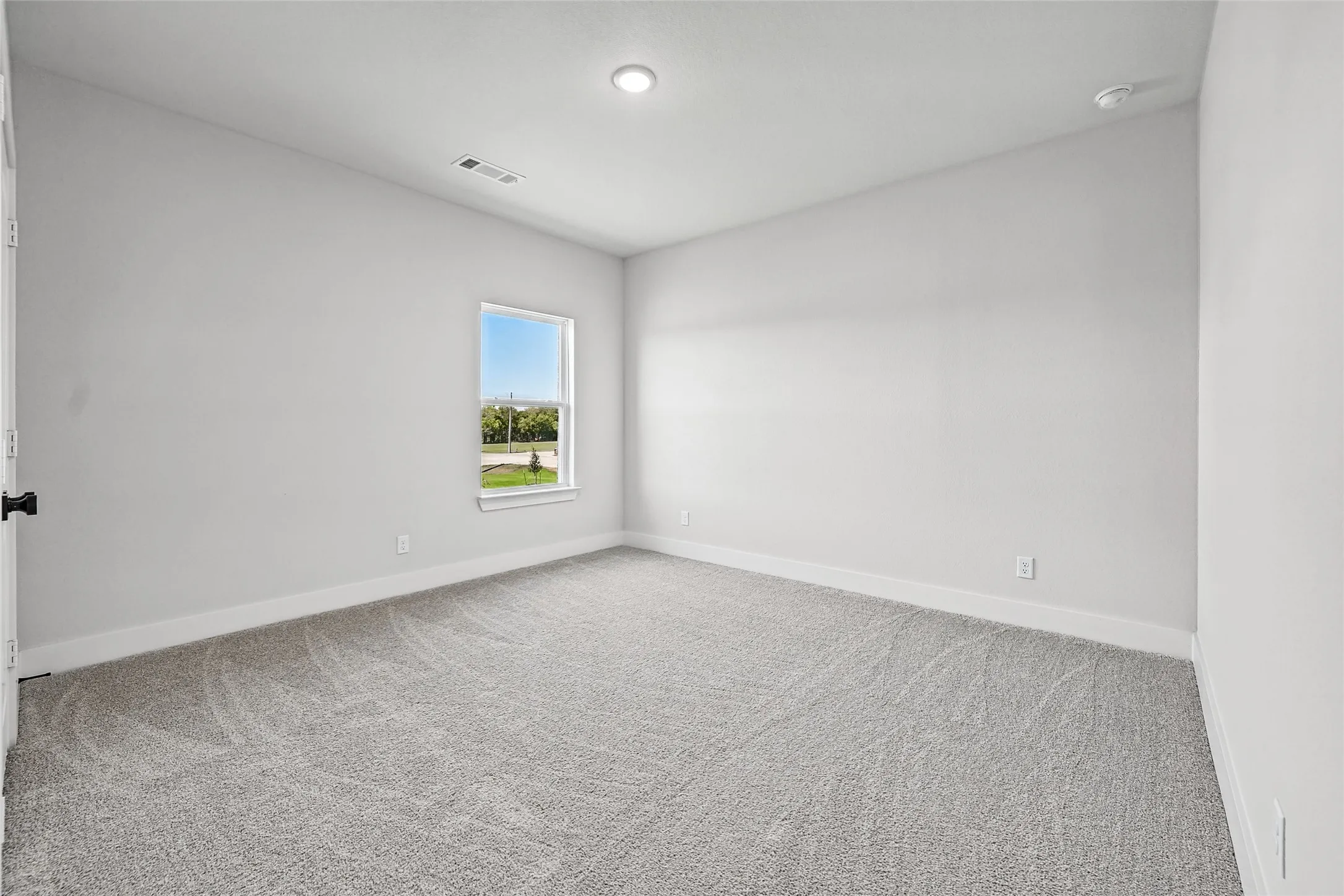 Neutral-toned walls complement the gray carpeting