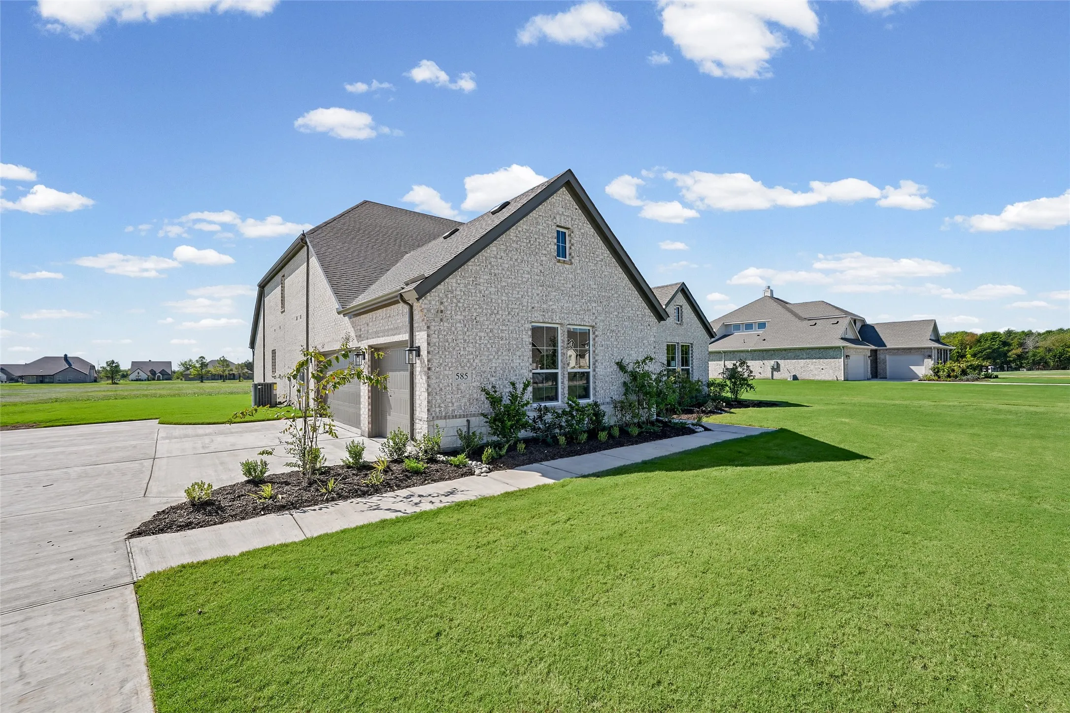 Brick exterior construction with an attached two-car garage