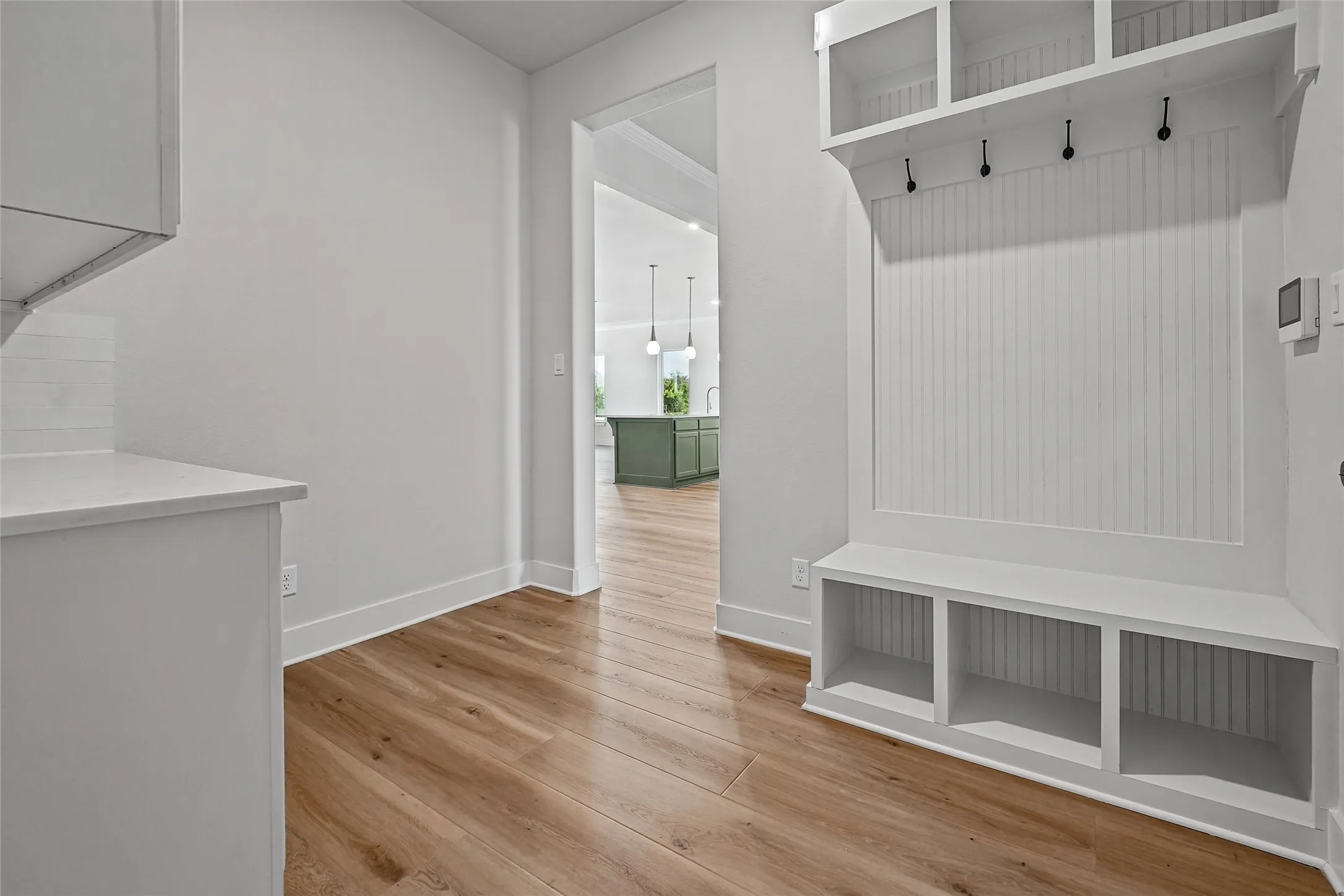 Built-in mudroom bench with cubby storage and beadboard paneling