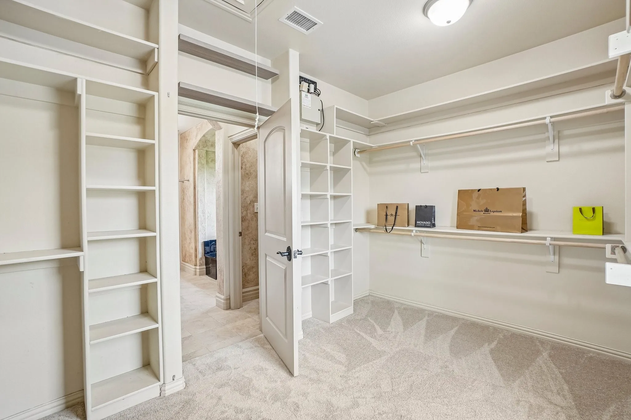 2nd view of walk-in closet in primary bathroom