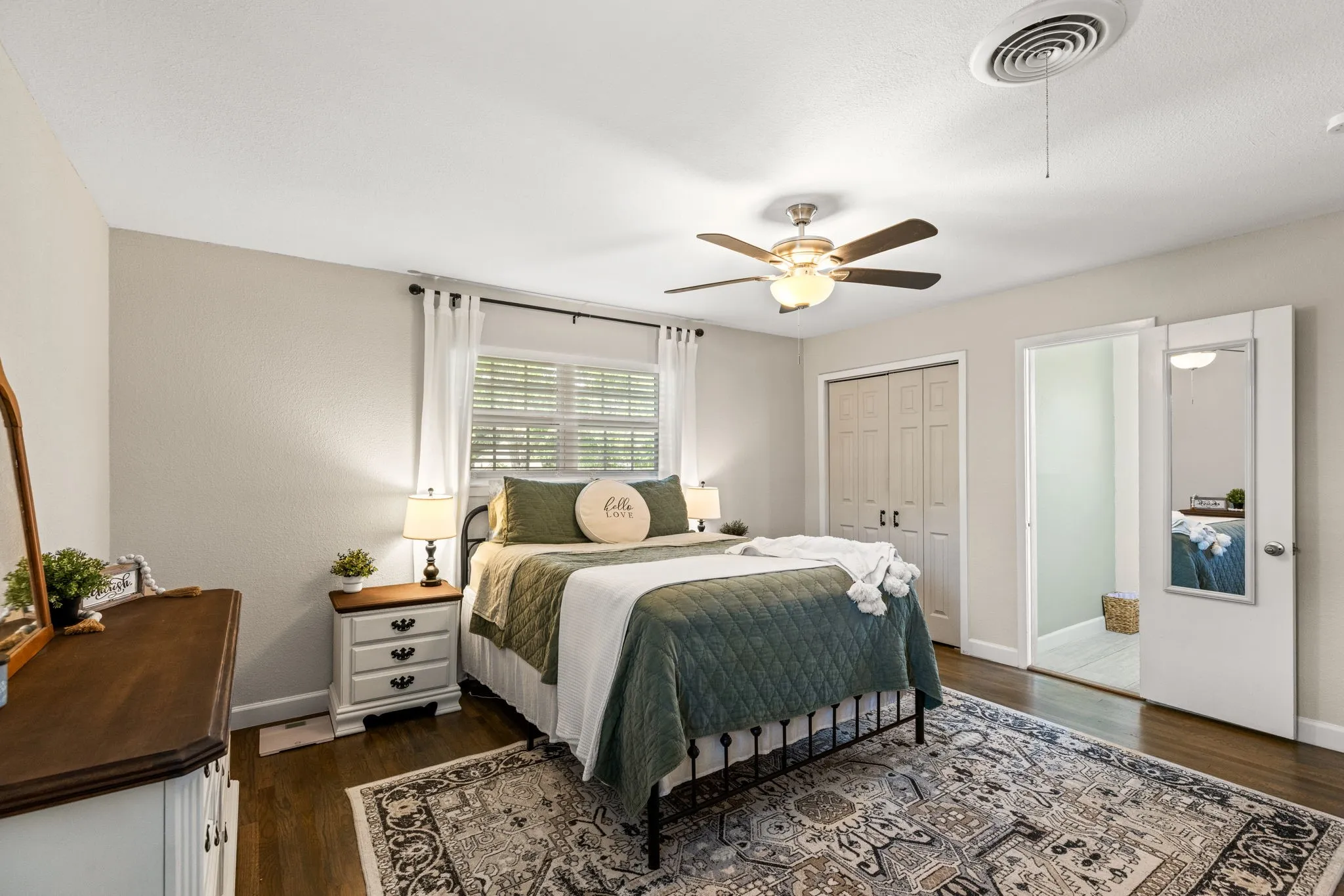 Warm-toned wood-finish flooring complements the light wall color