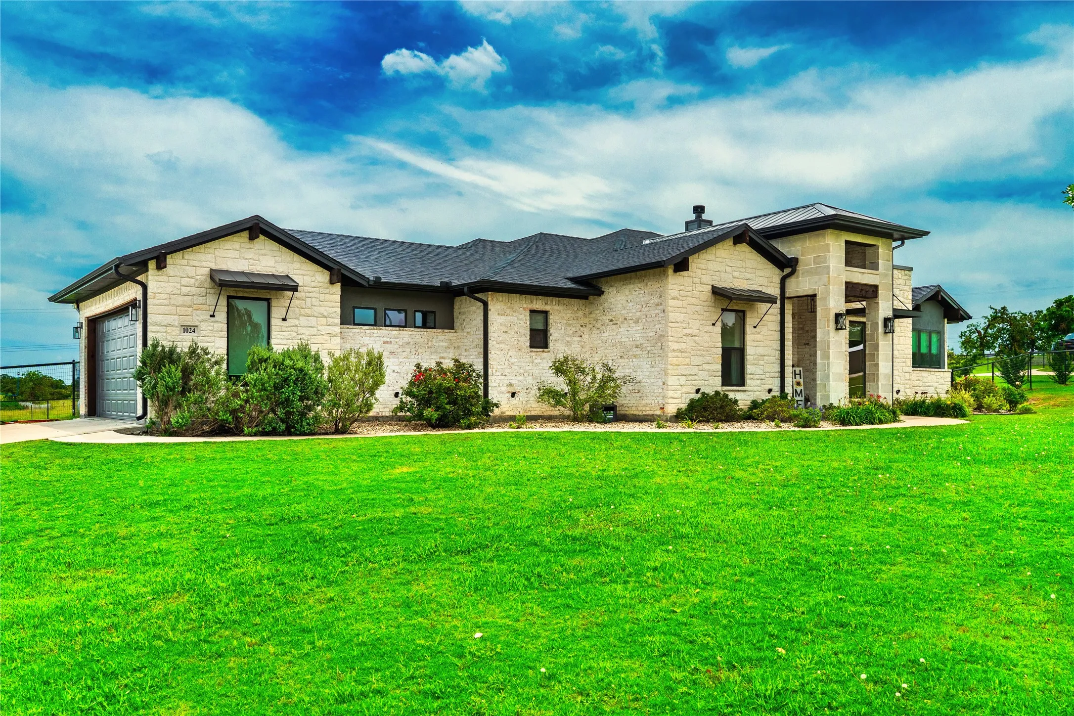 Contemporary exterior with light-toned stone masonry and dark trim accents