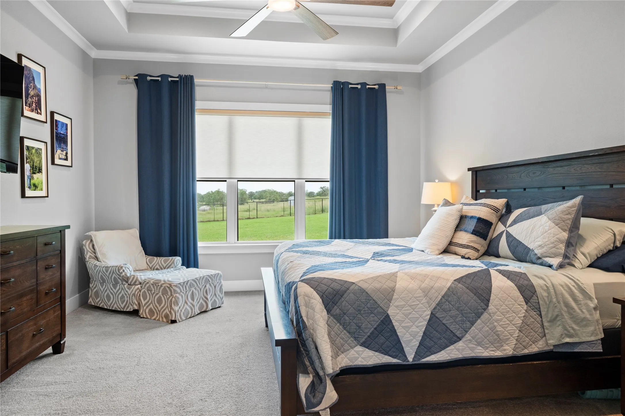 Bedroom featuring a tray ceiling with a flush-mount ceiling fan, neutral wall paint, and plush carpet flooring