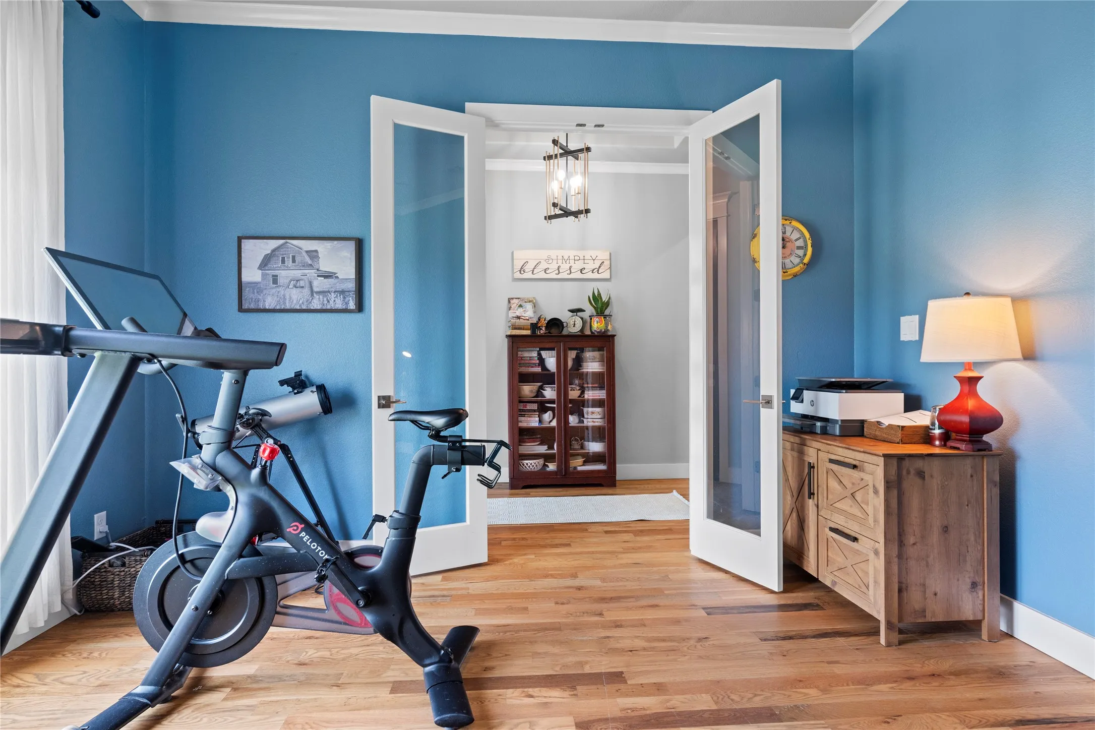 Hardwood flooring throughout featuring French doors with glass panels