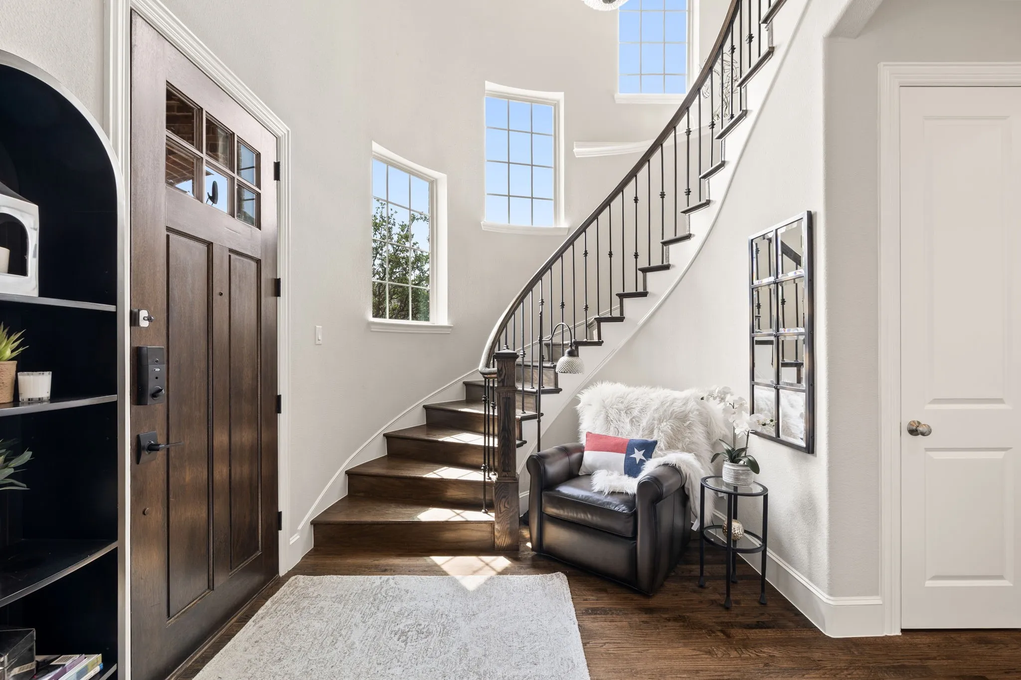 Sweeping staircase  entry with lots of natural light.