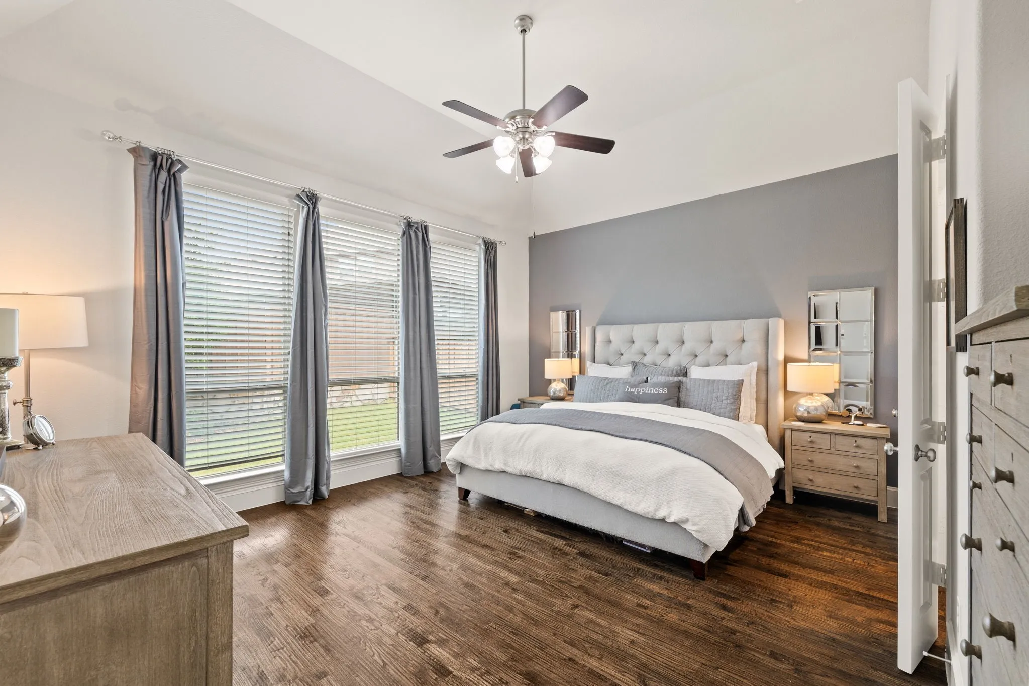 Primary is large enough for sitting area and looks out onto the expansive and private backyard.