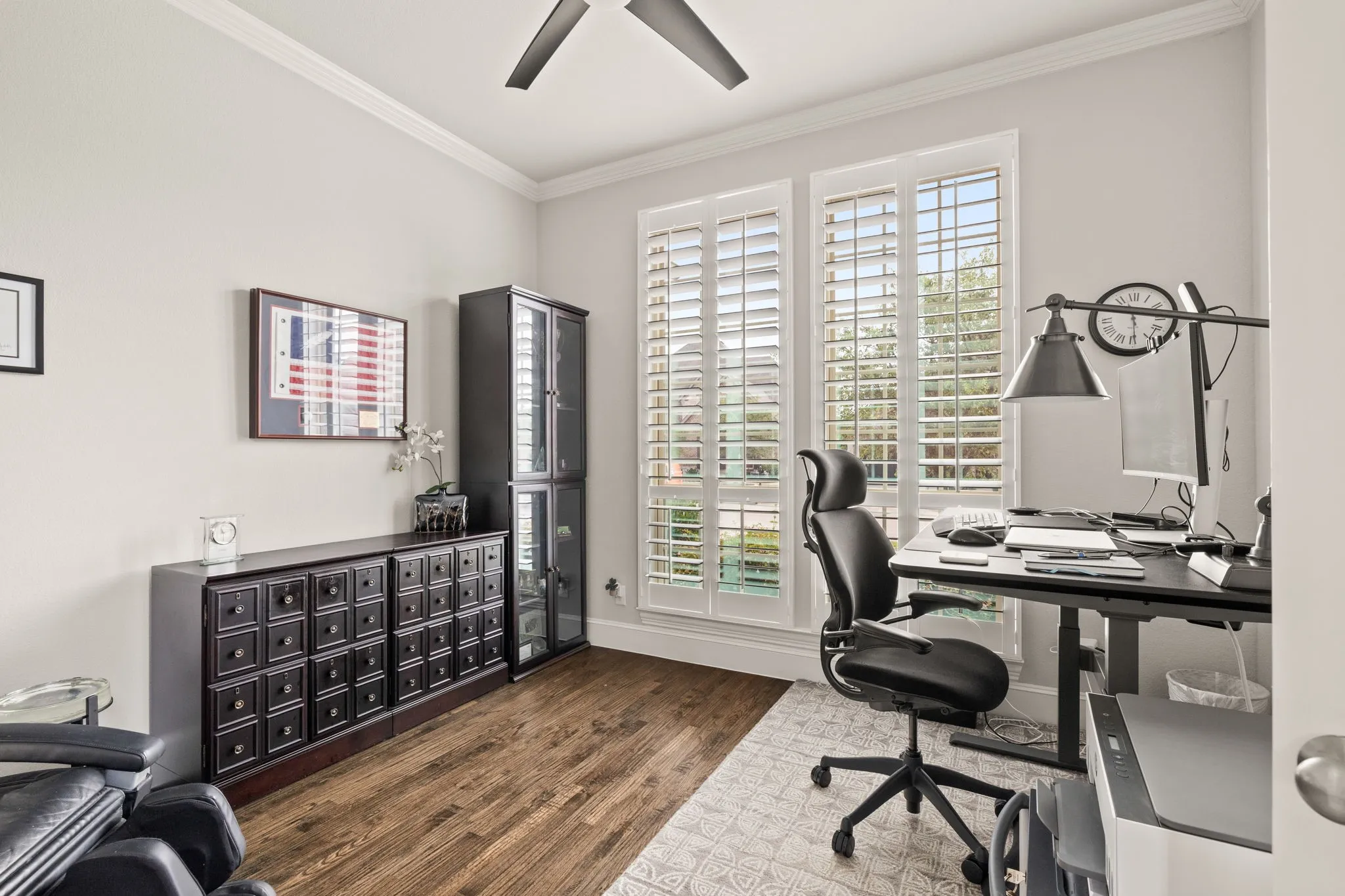 Light and bright office in front of home. Plantation shutters.